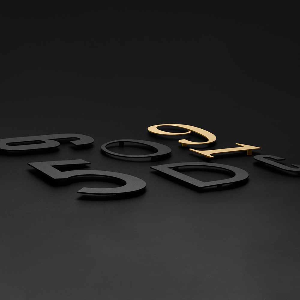 Talon kirjain Koti - Musta